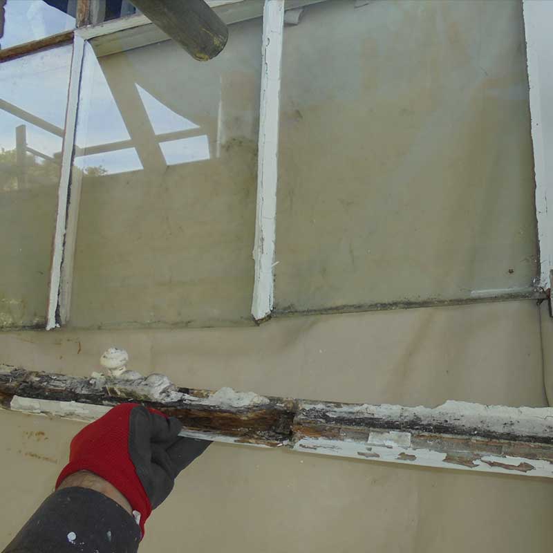 Timber Window Conservation - wood framed sash window being carefully removed ready for restoration