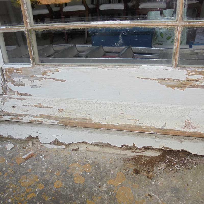 Timber Window Conservation - Wooden framed glazed doors being prepared for redecoration